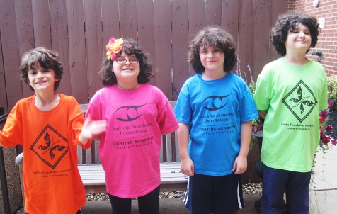 Four sibling children in colorful AFI shirts