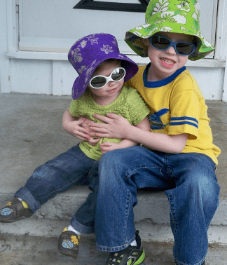 Siblings with sunglasses smiling